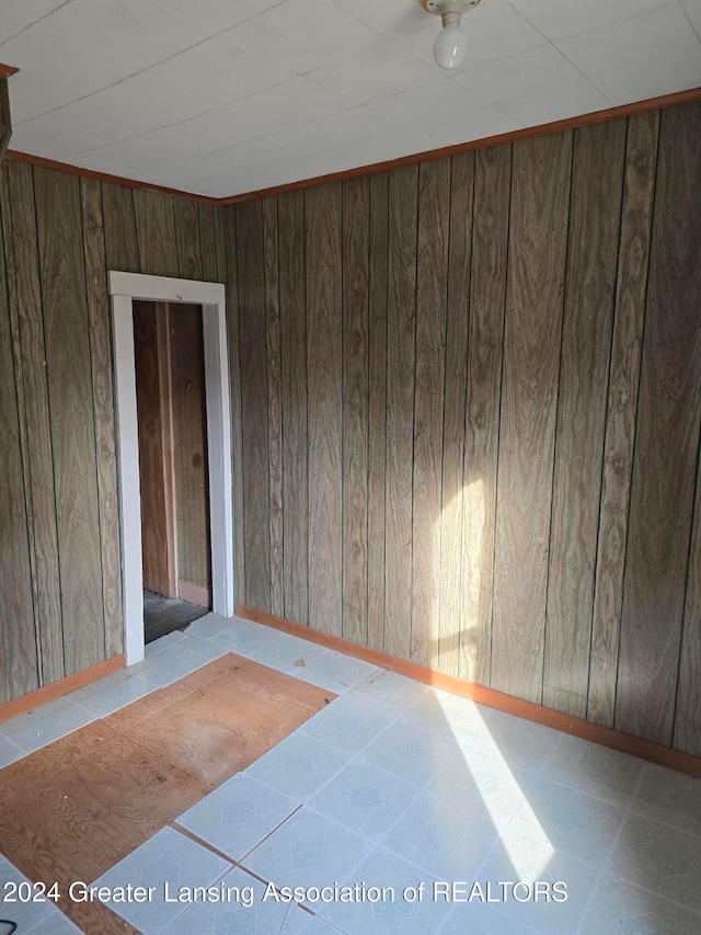 empty room featuring wooden walls