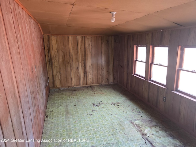 empty room featuring wooden walls