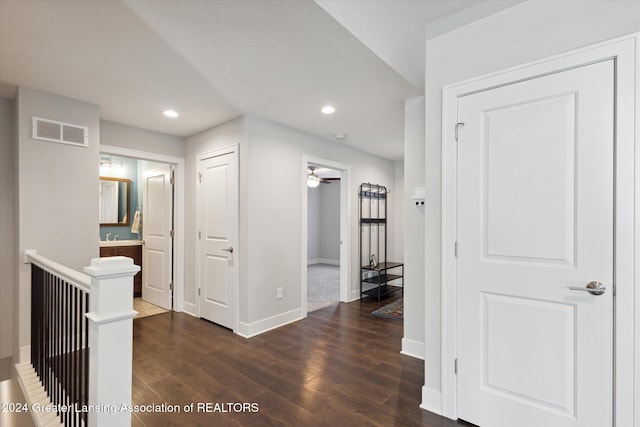 corridor with dark hardwood / wood-style flooring