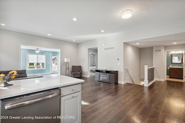 kitchen featuring dishwasher, dark hardwood / wood-style floors, white cabinets, light stone counters, and ceiling fan