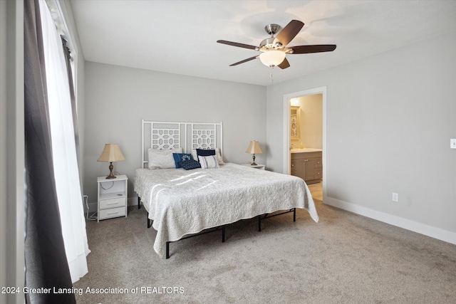 bedroom with ceiling fan, carpet floors, and ensuite bath