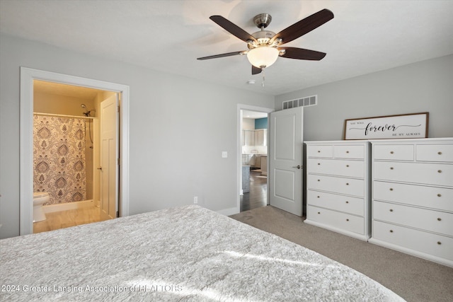 carpeted bedroom with connected bathroom and ceiling fan