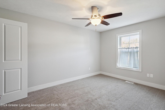 spare room with carpet floors and ceiling fan