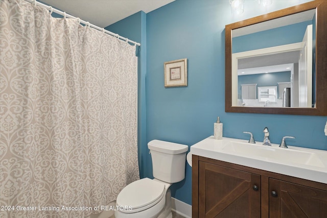 bathroom featuring toilet and vanity