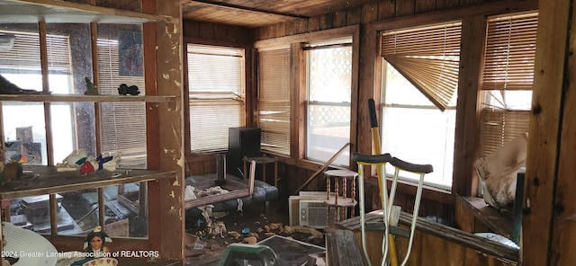 sunroom / solarium featuring wood ceiling and plenty of natural light