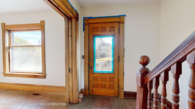 foyer with hardwood / wood-style flooring and a healthy amount of sunlight