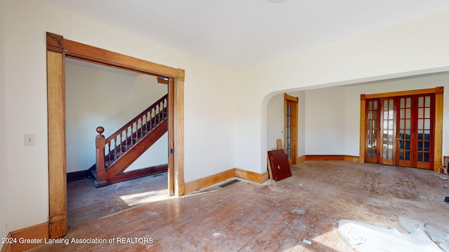 unfurnished room featuring hardwood / wood-style flooring and french doors