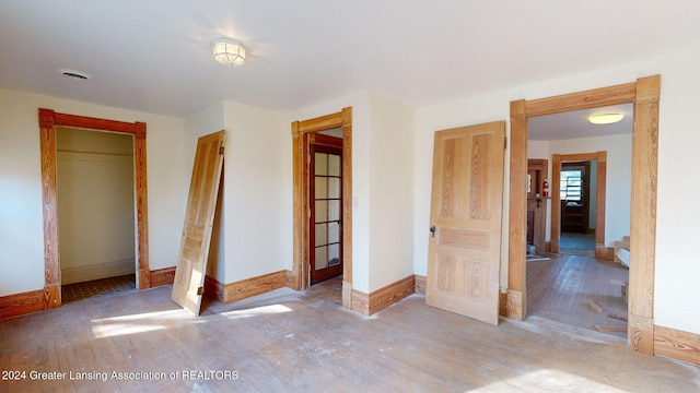 unfurnished bedroom featuring a closet and light hardwood / wood-style floors