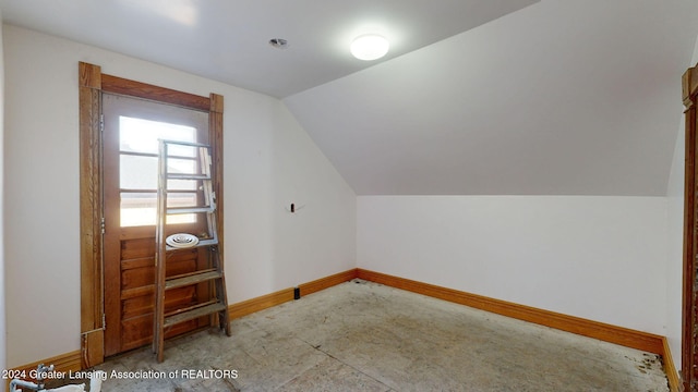 additional living space featuring lofted ceiling