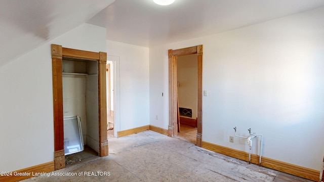 unfurnished bedroom featuring a closet and vaulted ceiling