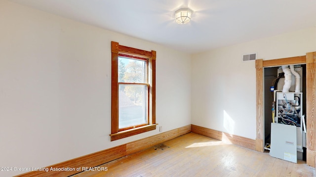 unfurnished room with light wood-type flooring