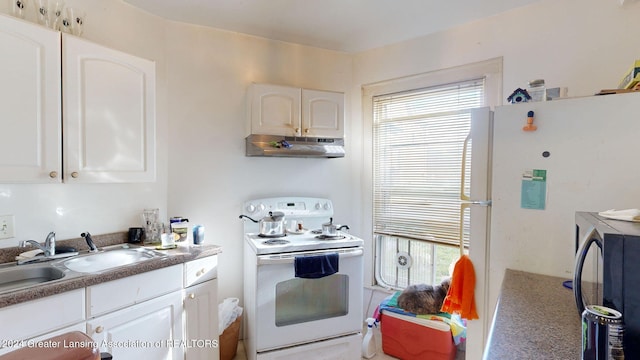 kitchen featuring extractor fan, plenty of natural light, white cabinetry, and white appliances