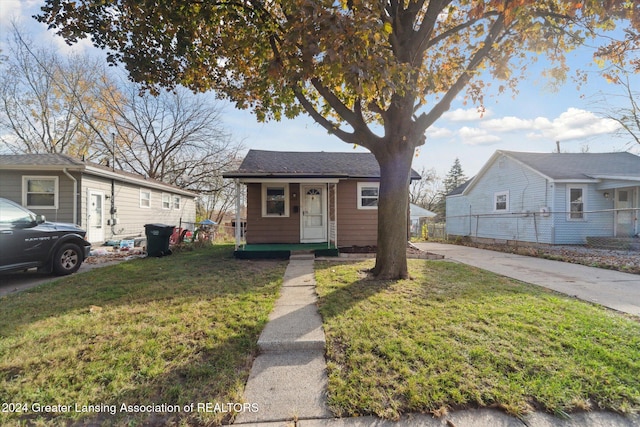 bungalow-style house with a front lawn