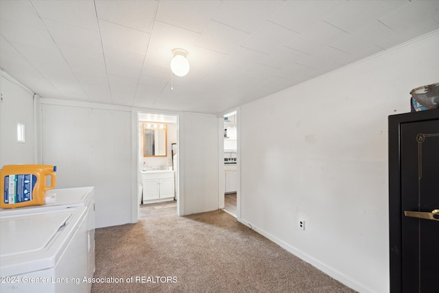 laundry room with washer and clothes dryer and light carpet