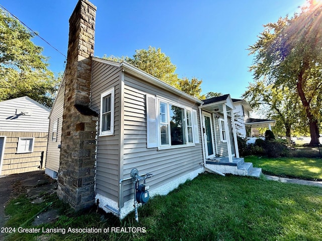 view of side of property with a lawn