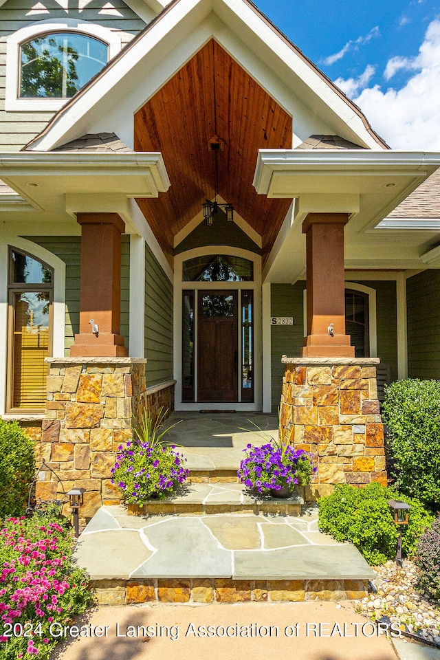 view of exterior entry with covered porch