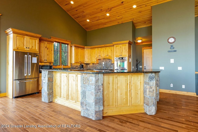 kitchen featuring appliances with stainless steel finishes, light hardwood / wood-style flooring, high vaulted ceiling, and wood ceiling