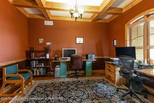 office space with dark wood-type flooring, coffered ceiling, and an inviting chandelier