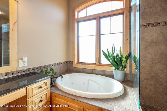 bathroom with vanity and a washtub