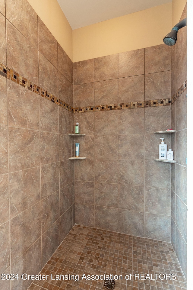 bathroom with a tile shower