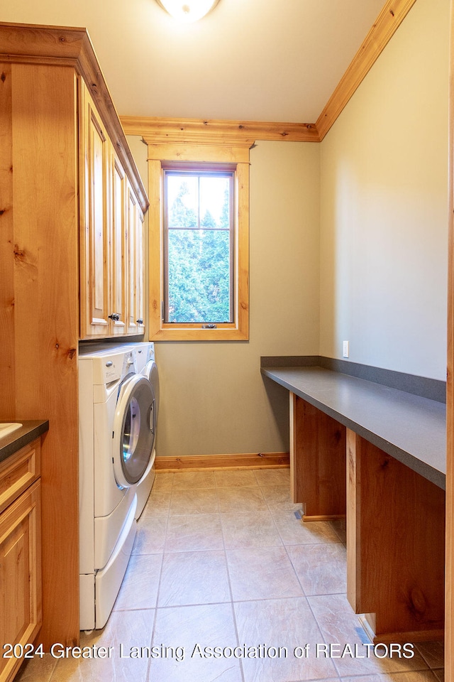 laundry room featuring cabinets, independent washer and dryer, ornamental molding, and light tile patterned floors