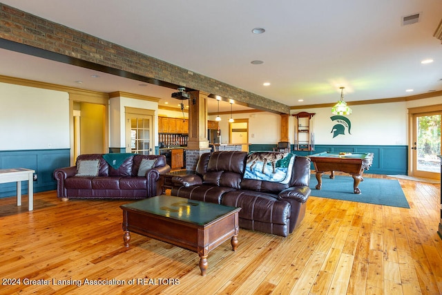 living room featuring light hardwood / wood-style floors, decorative columns, ornamental molding, and pool table