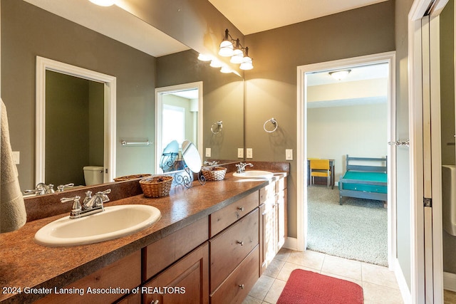 bathroom with vanity, toilet, and tile patterned flooring