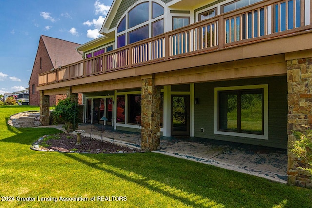 rear view of house featuring a yard and a patio area