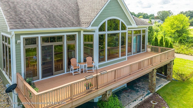 wooden deck with a sunroom