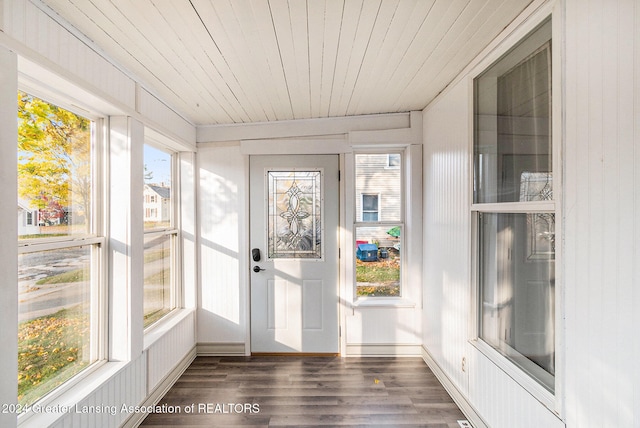 unfurnished sunroom featuring wood ceiling, lofted ceiling, and plenty of natural light