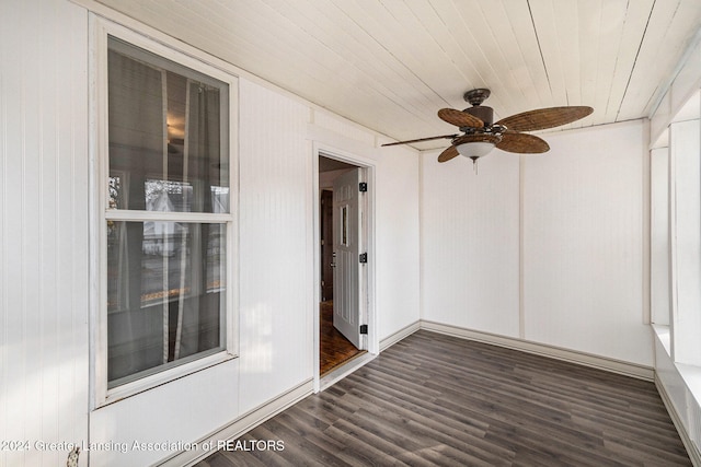 unfurnished sunroom featuring wood ceiling and ceiling fan