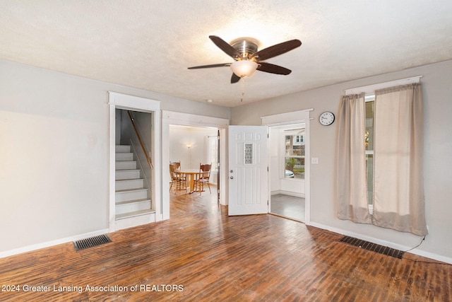 spare room with a textured ceiling, wood-type flooring, and ceiling fan