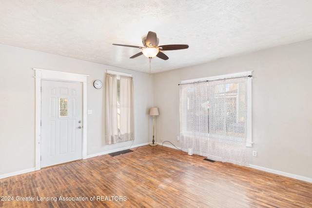 foyer with ceiling fan, hardwood / wood-style flooring, and a textured ceiling