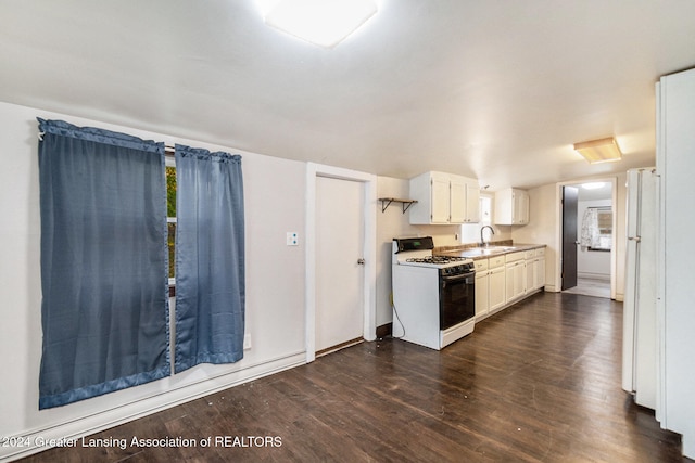 kitchen featuring white range with gas stovetop, sink, white cabinets, and dark hardwood / wood-style floors