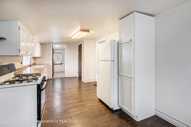 kitchen featuring white appliances, sink, dark hardwood / wood-style flooring, white cabinetry, and baseboard heating