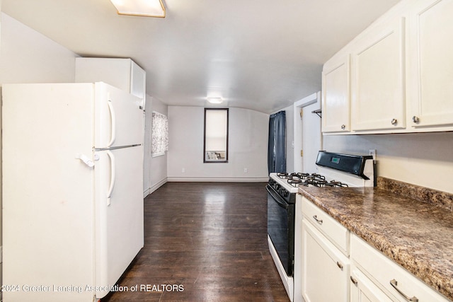 kitchen with white appliances, white cabinetry, dark hardwood / wood-style flooring, and dark stone counters