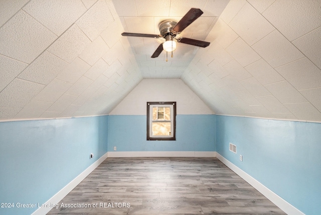 bonus room featuring hardwood / wood-style flooring, ceiling fan, and vaulted ceiling