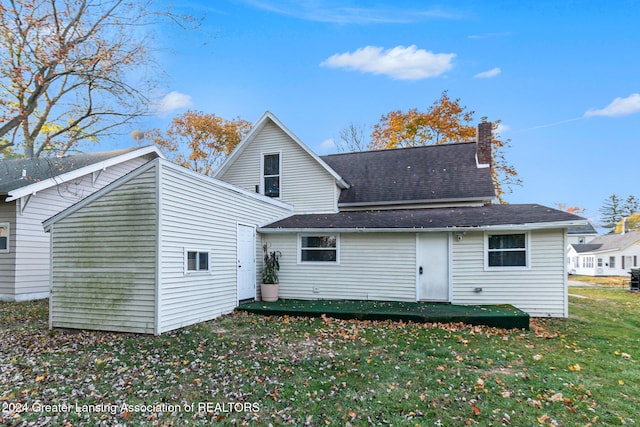 back of property with a lawn