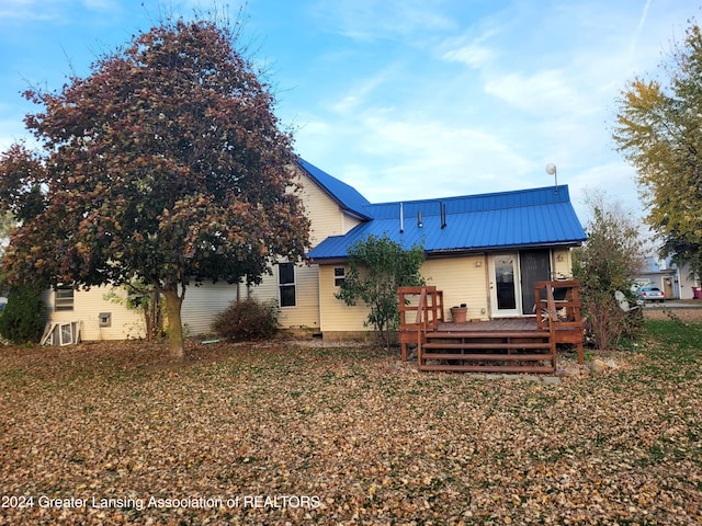 back of house featuring a deck