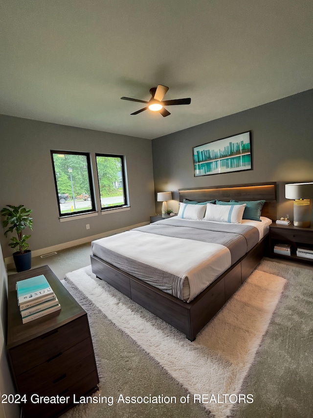 carpeted bedroom featuring ceiling fan