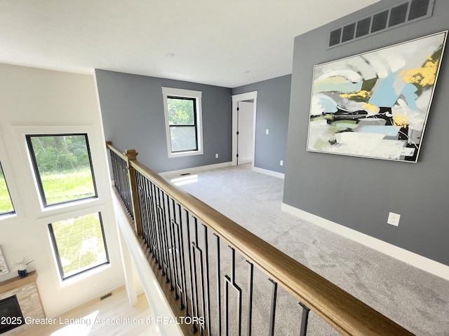 6119 Fresno Ln, East Lansing, MI 48823 - hall with carpet floors and an upstairs landing