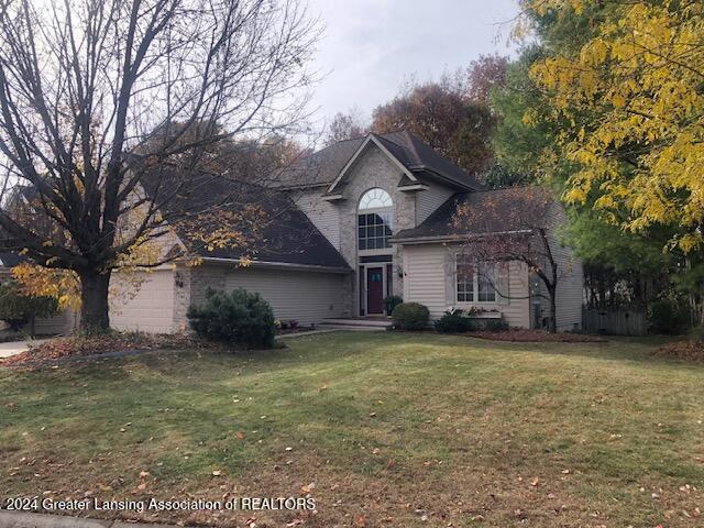 front facade featuring a front yard and a garage