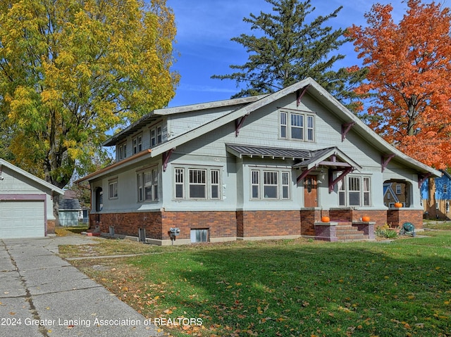 view of front of property featuring a front yard, an outdoor structure, and a garage