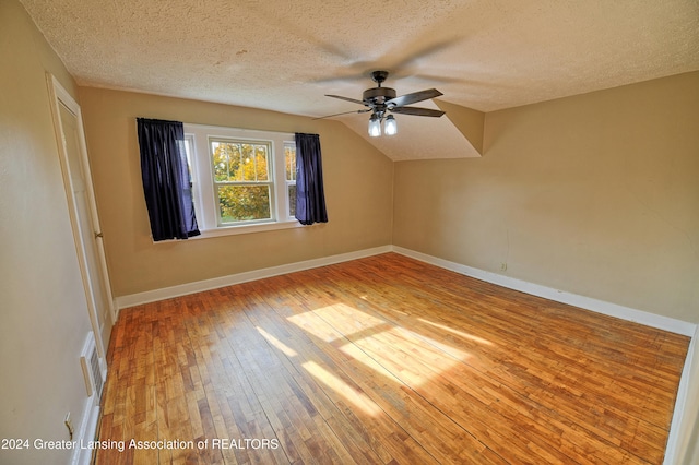 520 W St, Lansing, MI 48915 - additional living space featuring a ceiling fan, hardwood / wood-style floors, a textured ceiling, vaulted ceiling, and baseboards