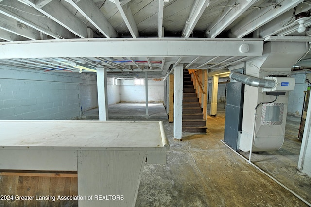 520 W St, Lansing, MI 48915 - unfinished basement featuring heating unit and stairway