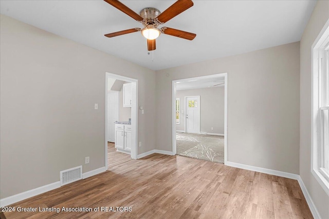 unfurnished room featuring ceiling fan and light wood-type flooring