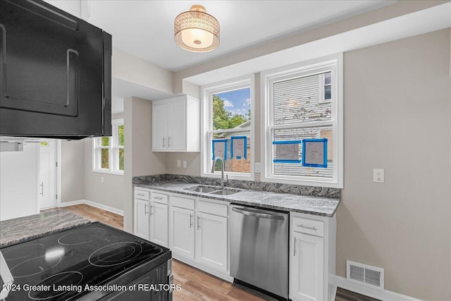 kitchen with white cabinets, a wealth of natural light, black range with electric cooktop, and dishwasher