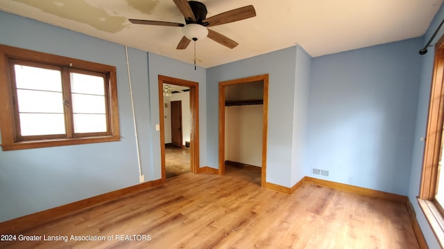 unfurnished bedroom featuring a closet, ceiling fan, and light hardwood / wood-style flooring