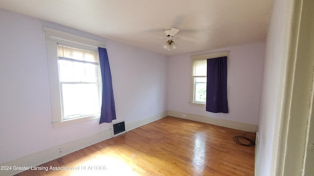 empty room featuring ceiling fan and light hardwood / wood-style floors