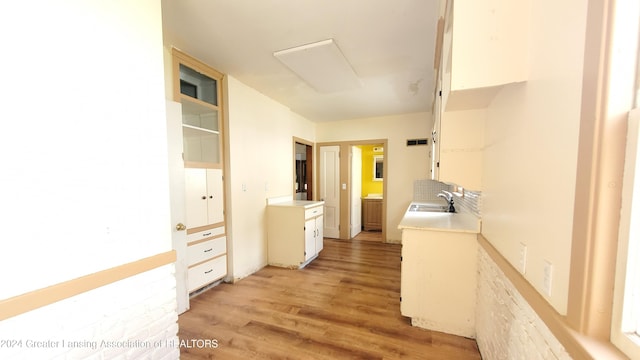 hallway with sink and light hardwood / wood-style flooring